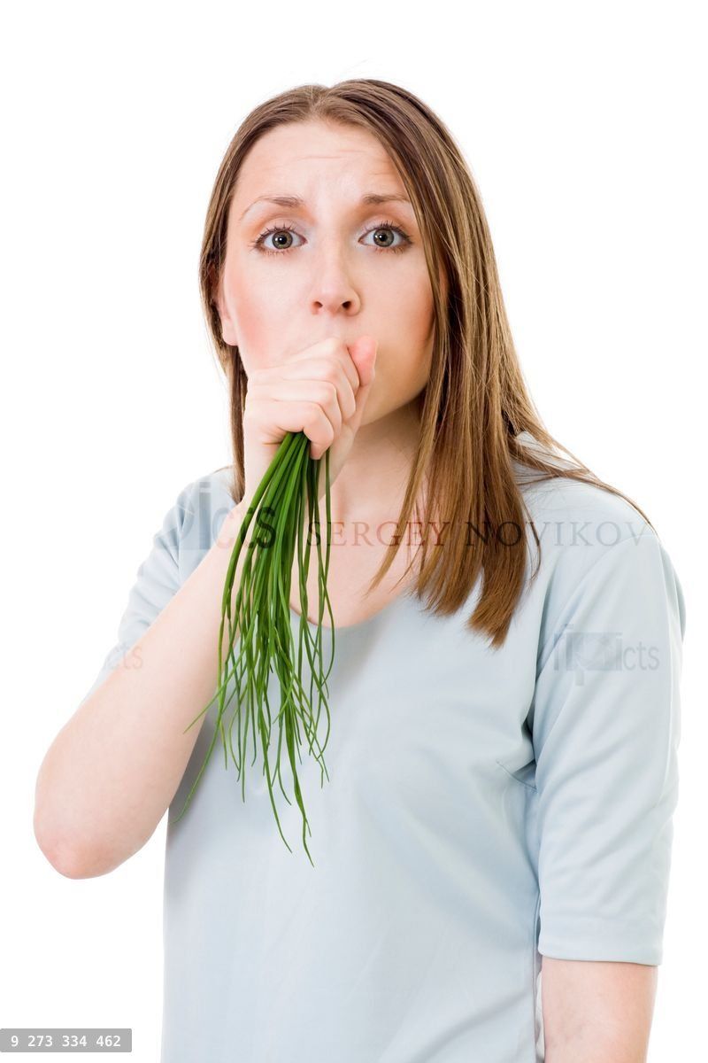 Woman eating bunch of onion