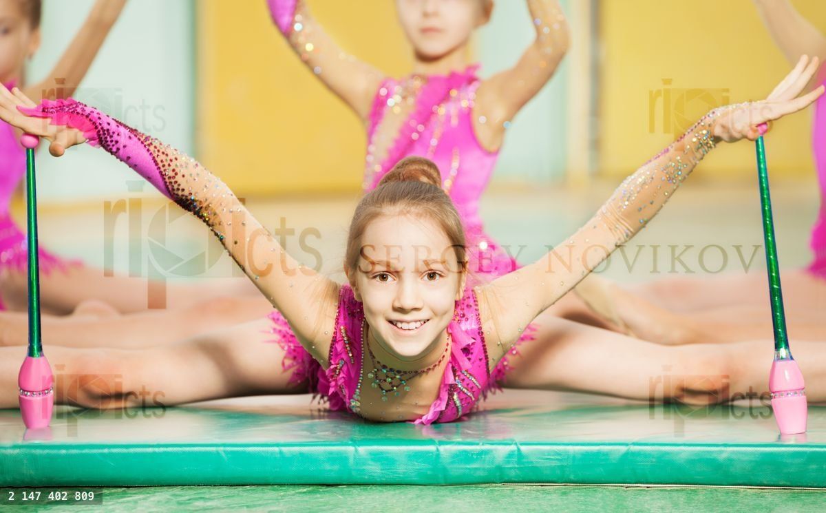Girl doing rhythmic gymnastics with Indian clubs