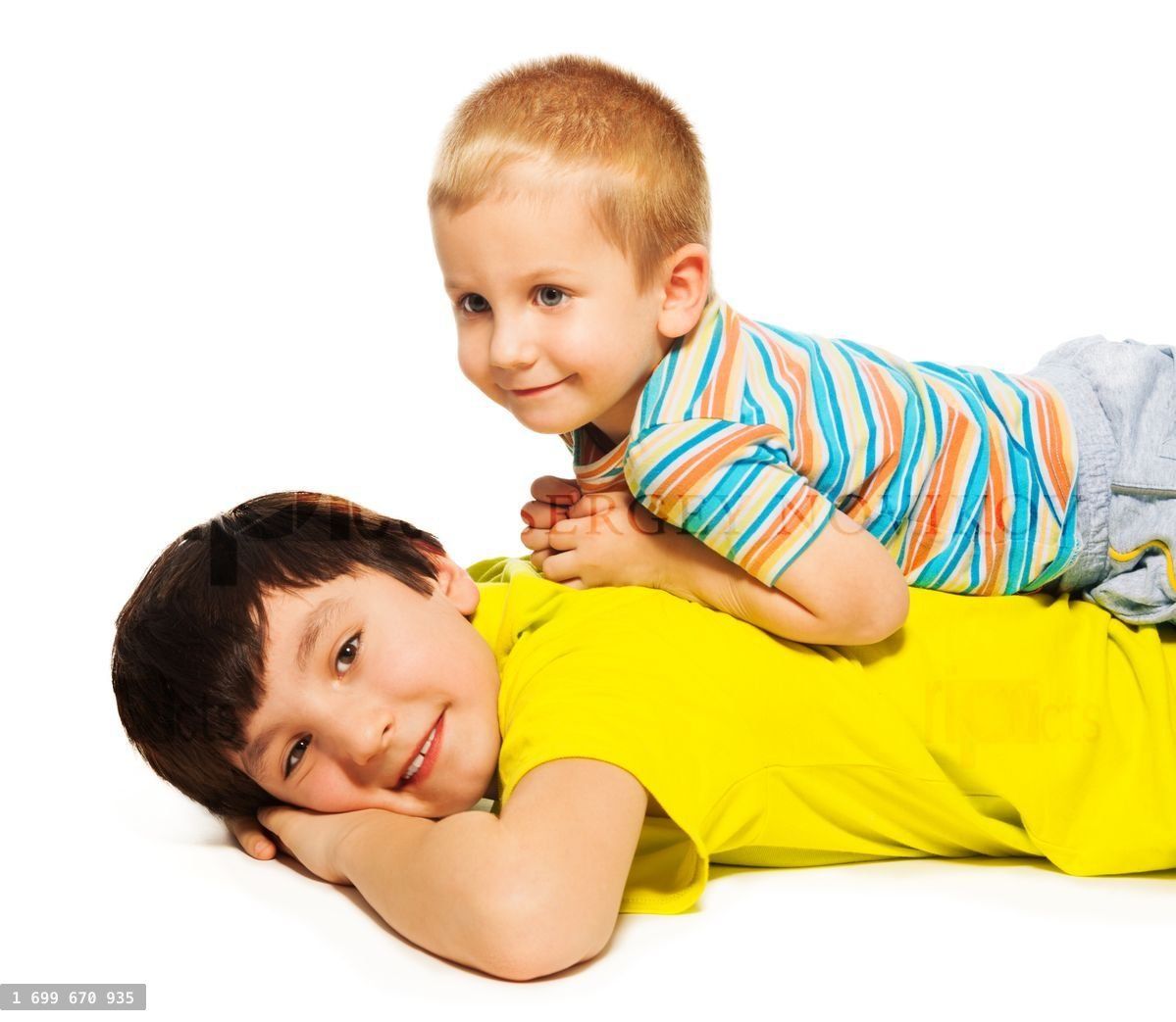 Young brother laying on the back of bigger