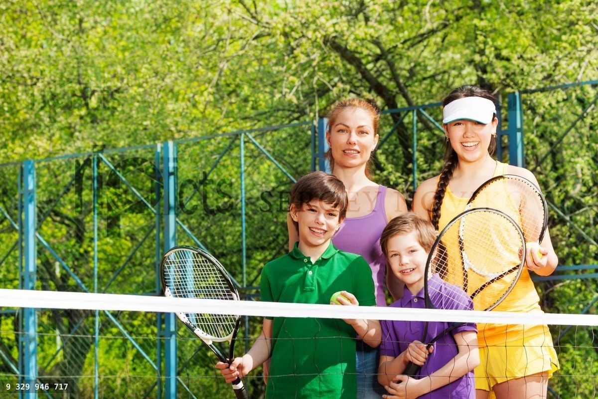 Sporty family preparing to start a tennis set