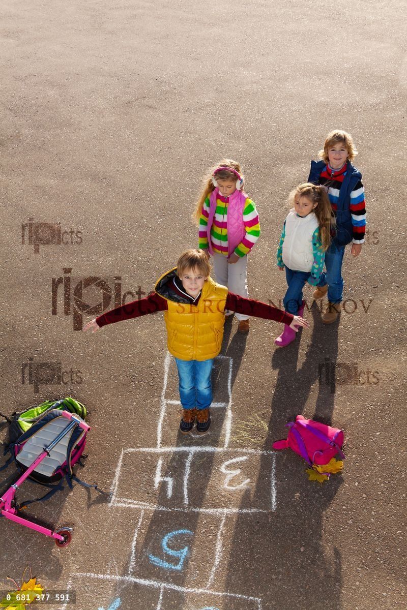 Boy with friends play hopscotch