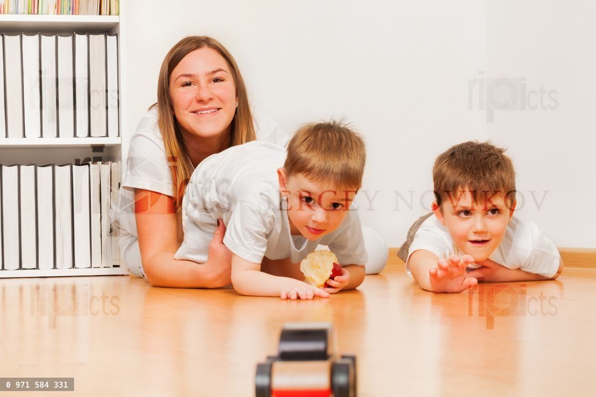 Young mother is playing with her two sons