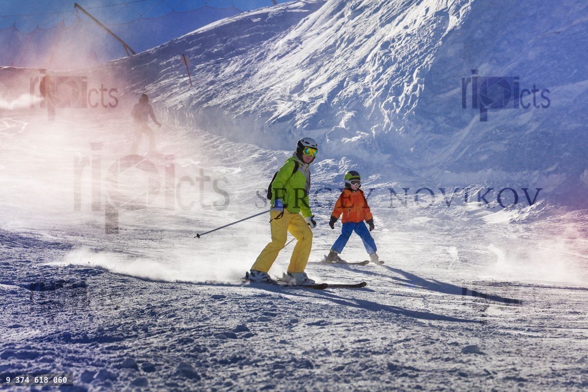 Mother and son ski down the mountain