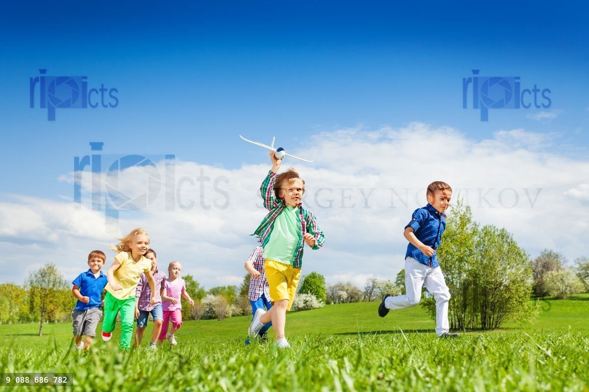 Running boy with airplane toy and other children
