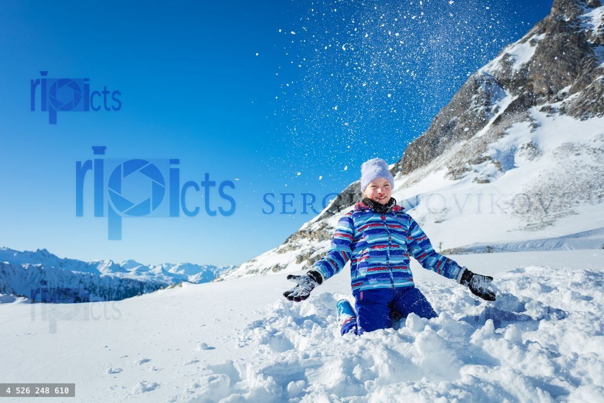 Young beautiful ski girl portrait throw up snow