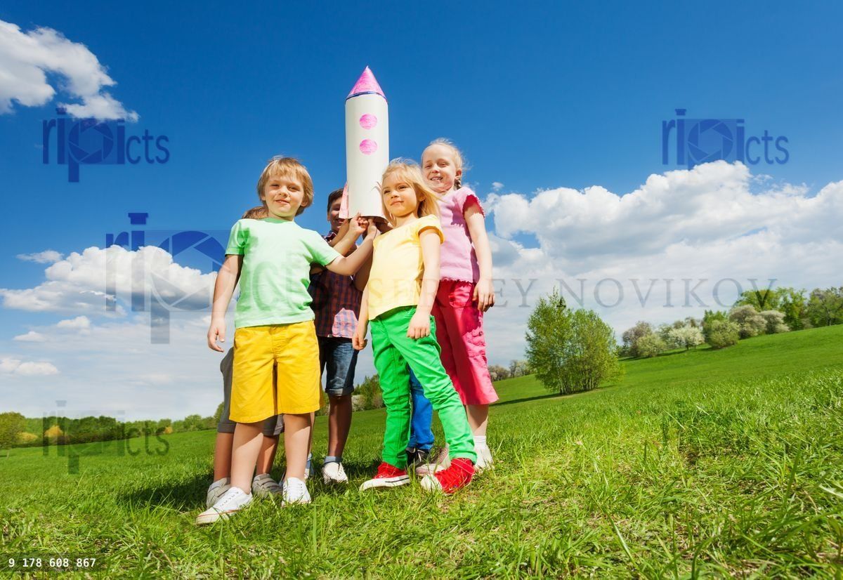 Kids standing in circle with carton rocket