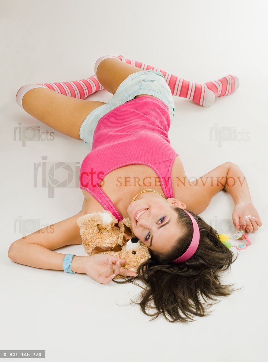 Young woman in pink lay with toy
