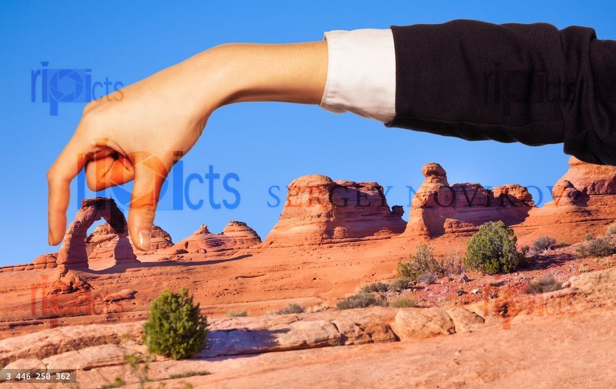 Woman's hand holding natural arch between fingers