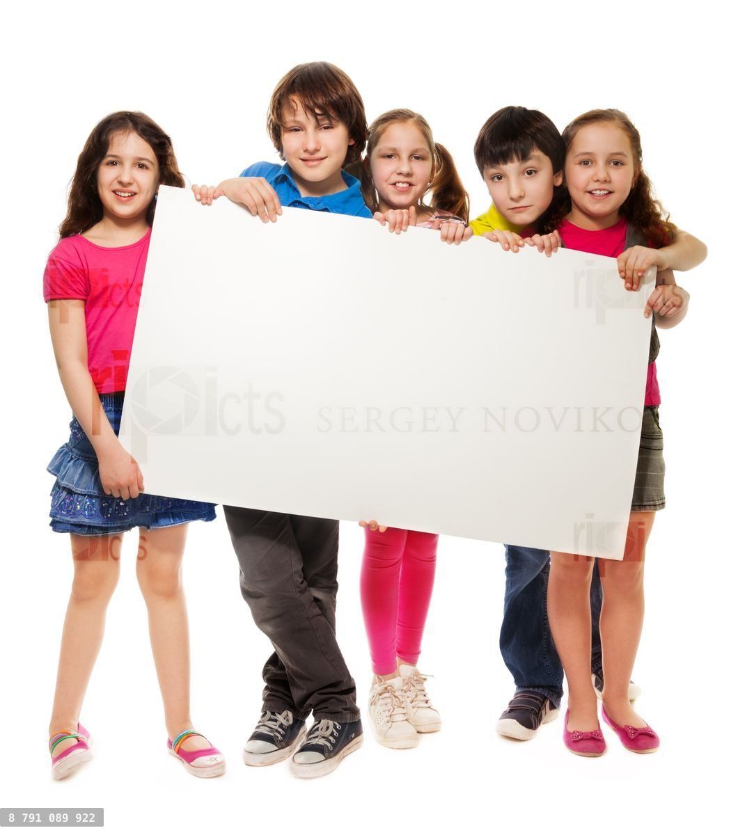 Group of schoolchildren holding white board