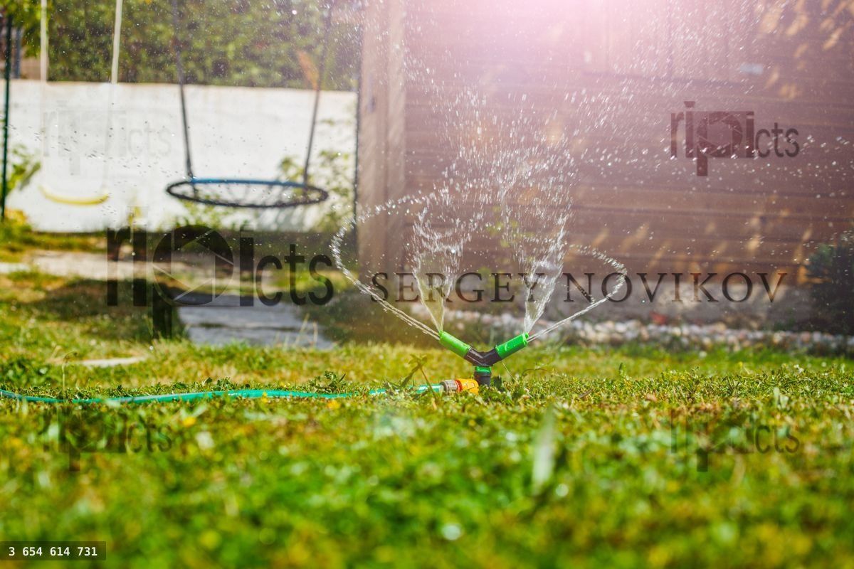 Gardening sprinkle irrigate garden lawn spraying water close up