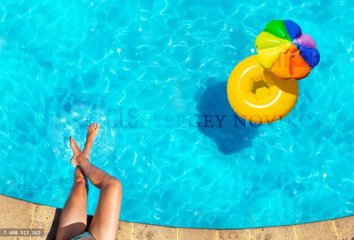 Woman's legs, inflatable ring swim in pool