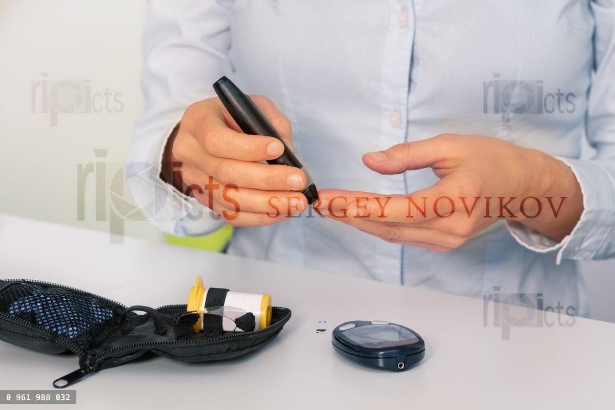 Woman make blood sugar diabetes test with tester