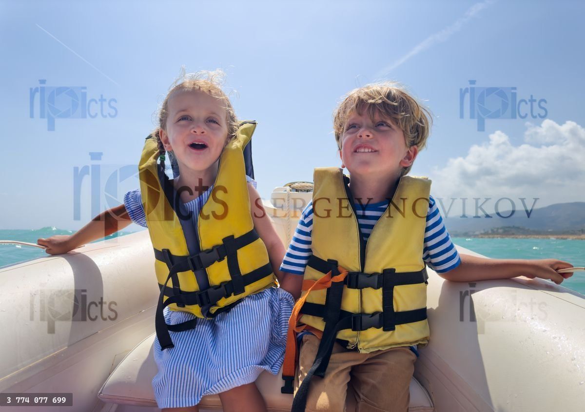 Young sailors sightseeing and have fun on a sunny day in sea
