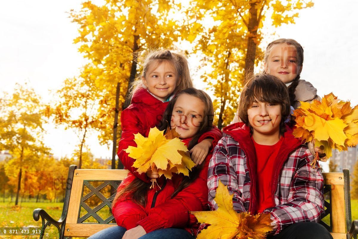 Four happy kids with maple bouquet
