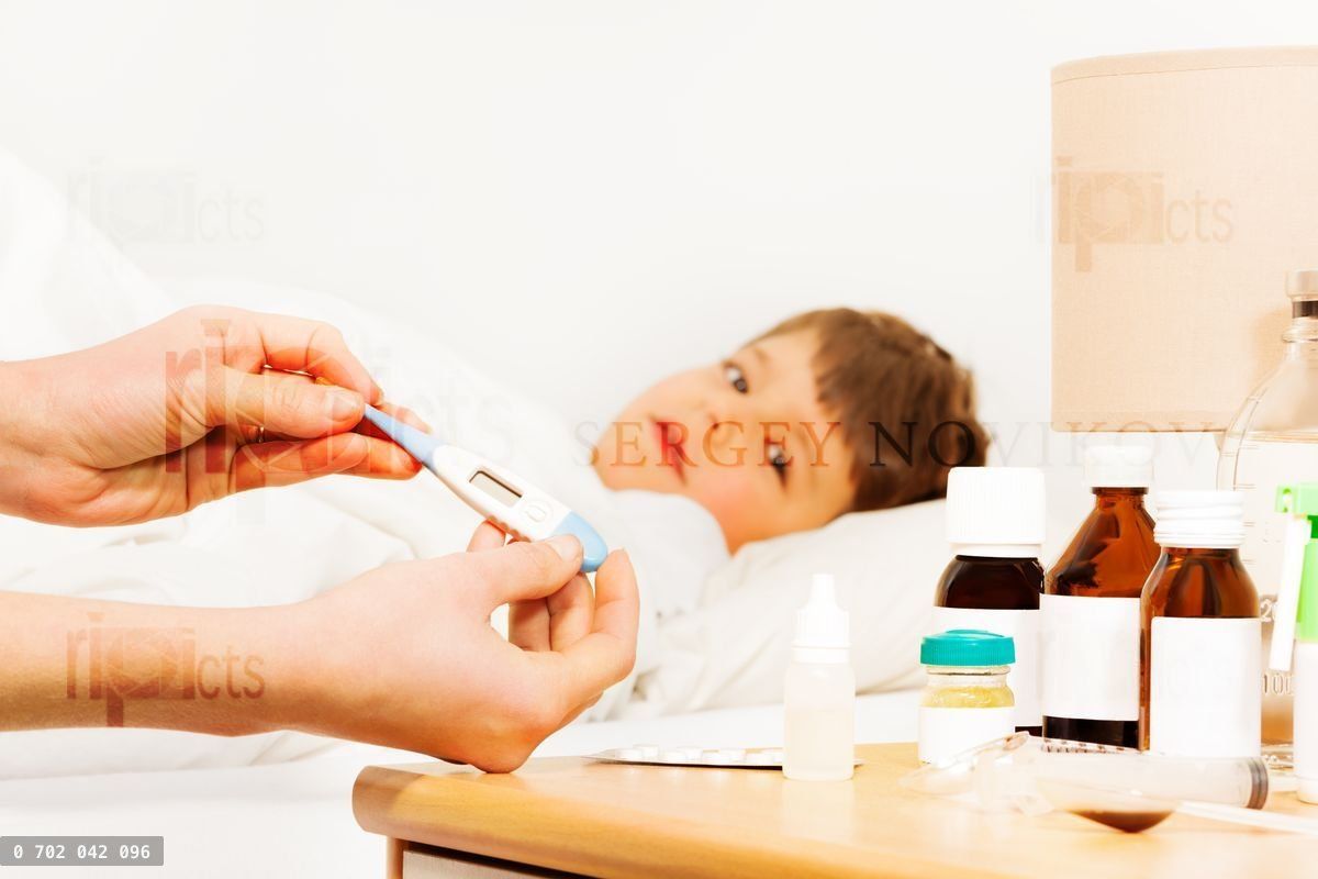 Woman holding thermometer and checking temperature