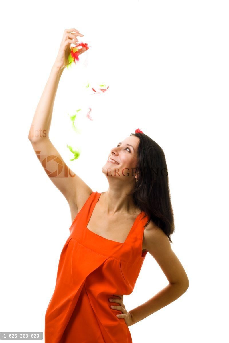 Young woman in orange dress with flying