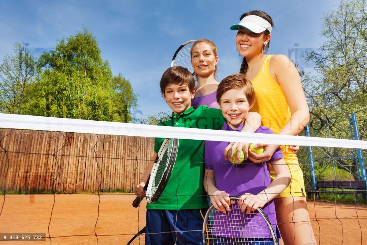 Happy family after playing tennis in summertime