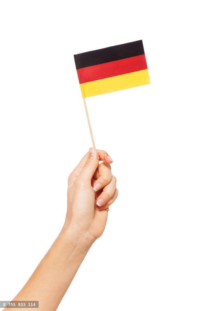 Woman's hand waving and raising small German flag