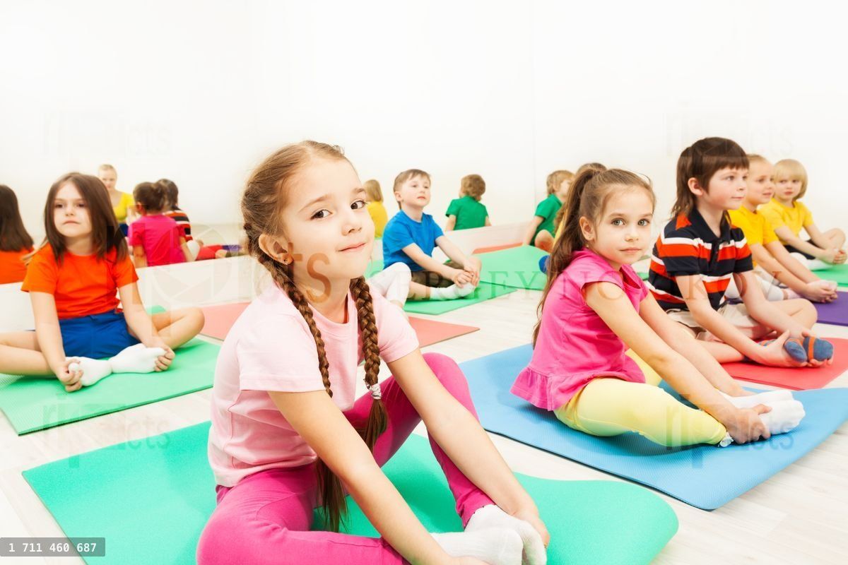Girl doing butterfly stretch in gymnastic group
