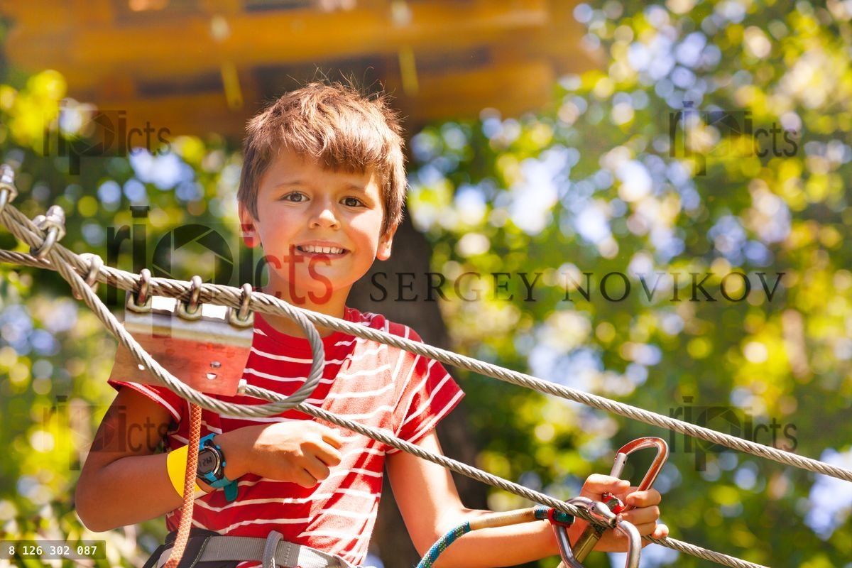 close portrait of the boy at rope park near cable