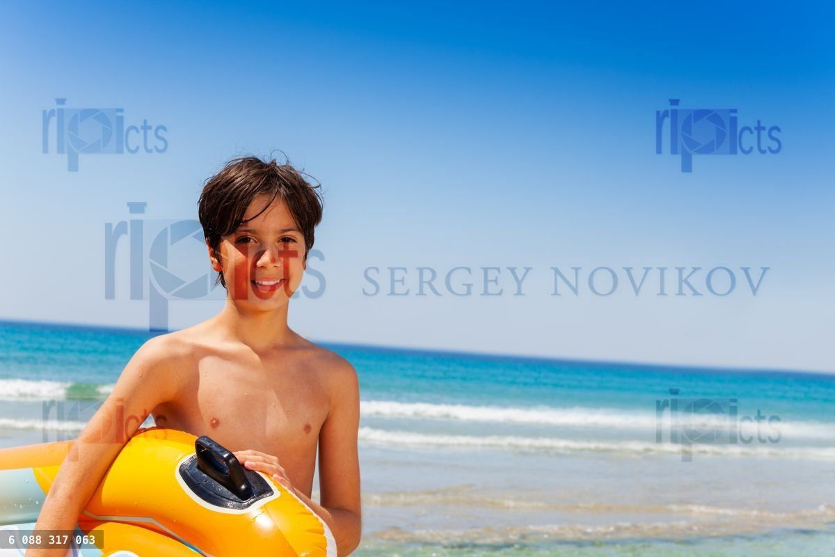 Happy boy ready for summer activities at seaside