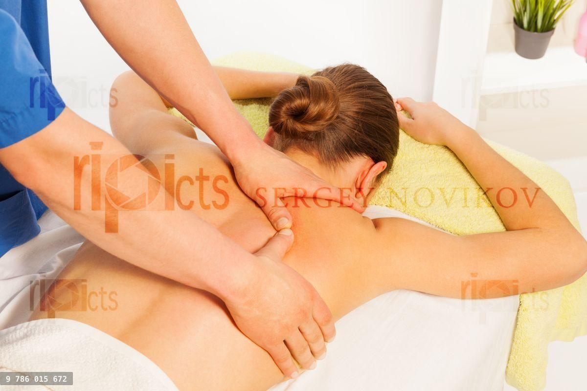 Young woman relaxing in spa massage salon