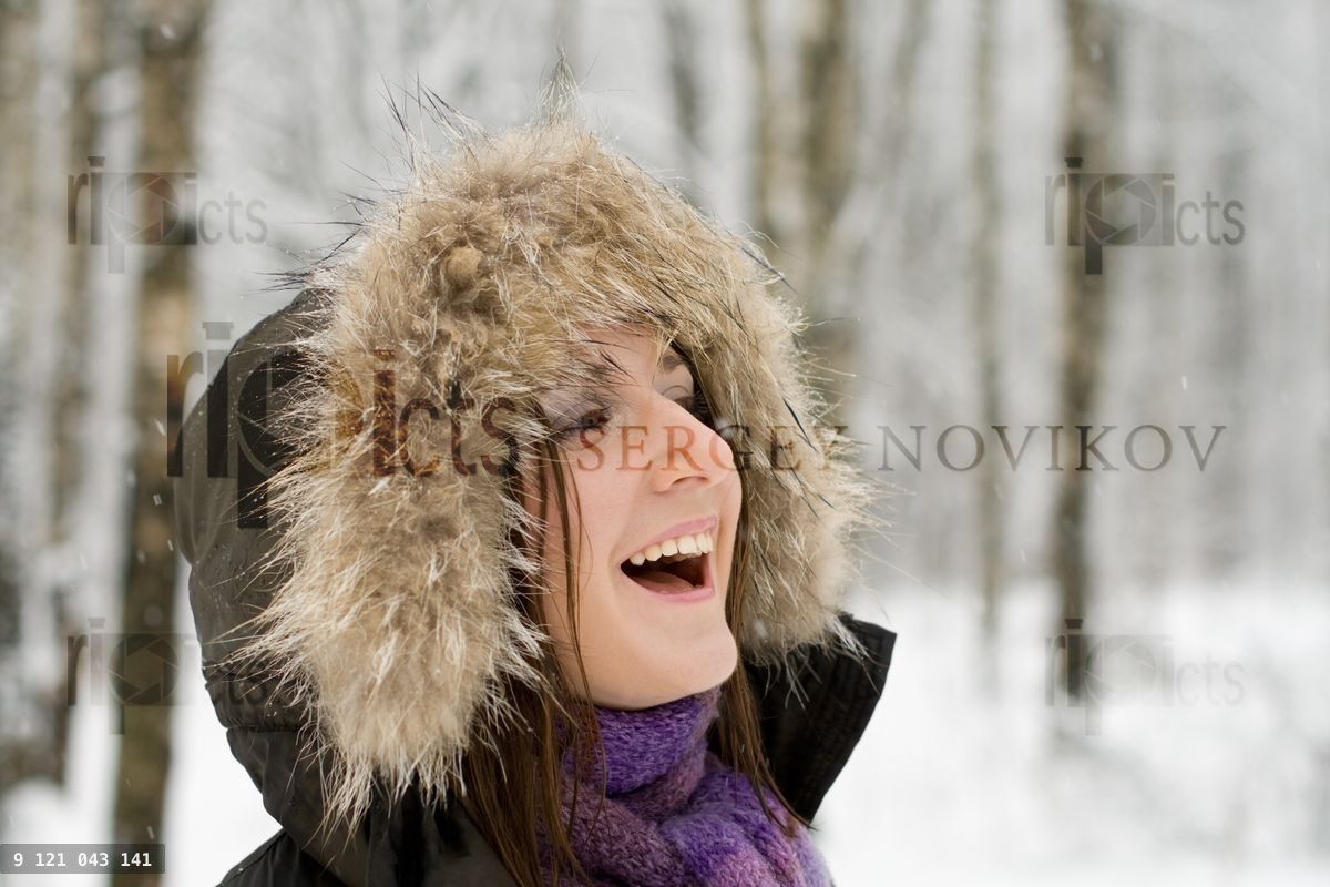 Woman in forest with fur hood