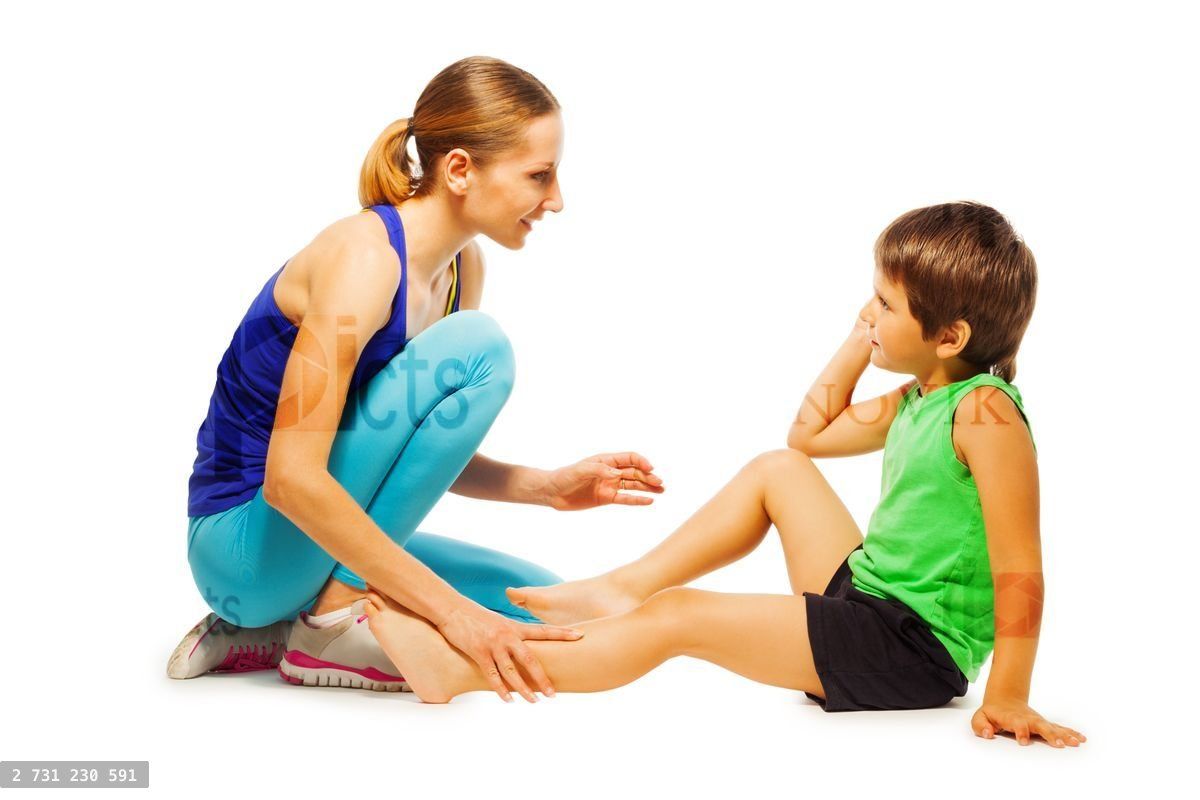 Young coach explaining how to do exercises for boy