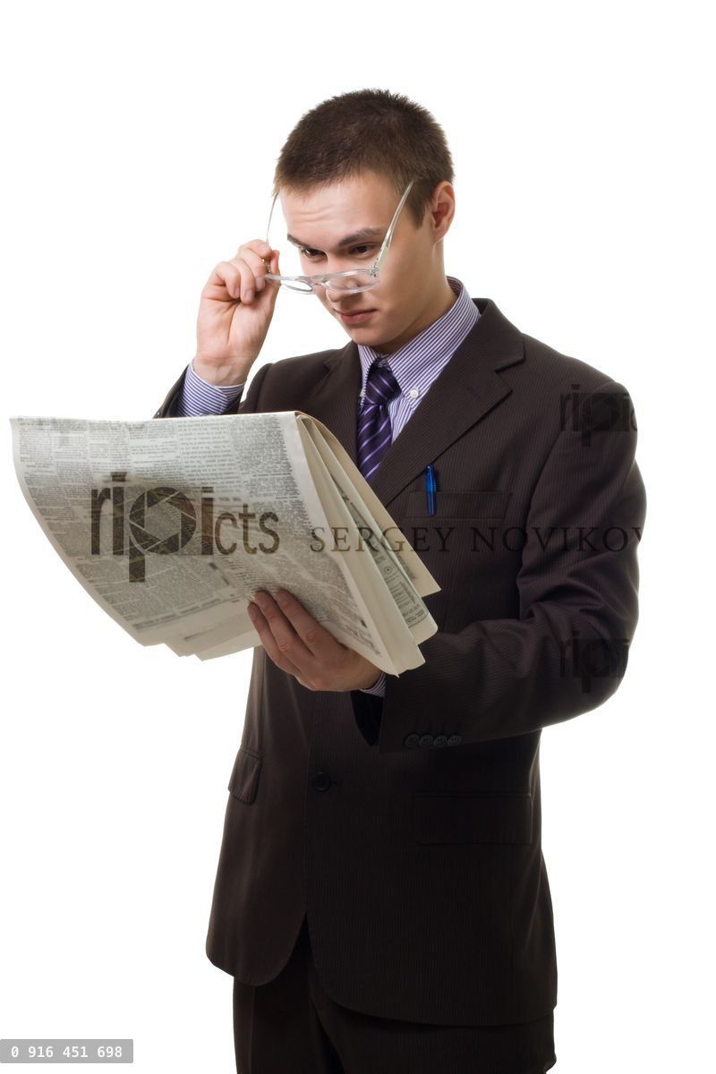 Young hansome man in suit with newspaper
