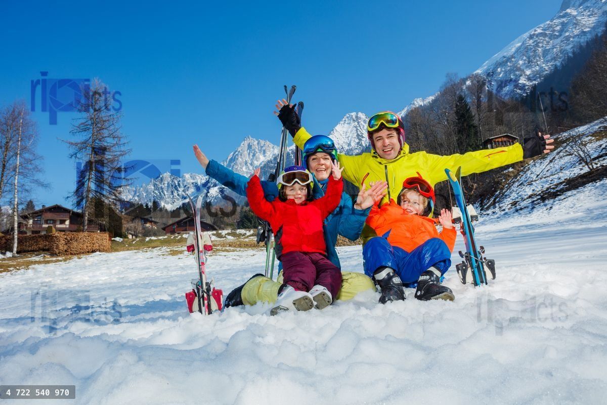 Happy ski vacation with kids dad and children cheer lift hands