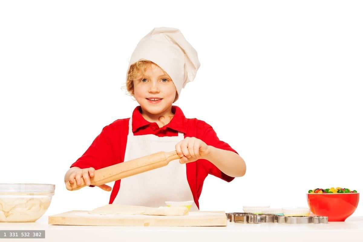 Young baker making dough with rolling pin