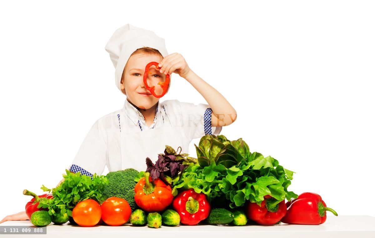 Young cook having fun with fresh vegetables