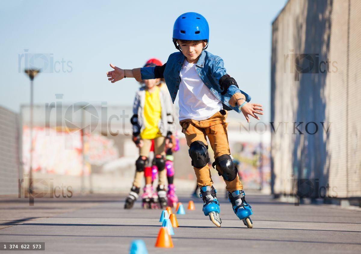 Young inline skater practicing forward slalom