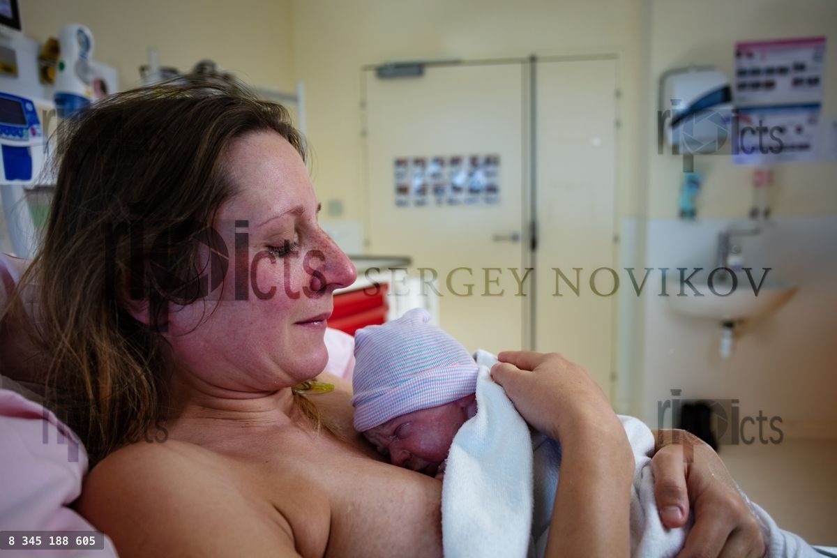 Woman hold newborn baby after giving birth