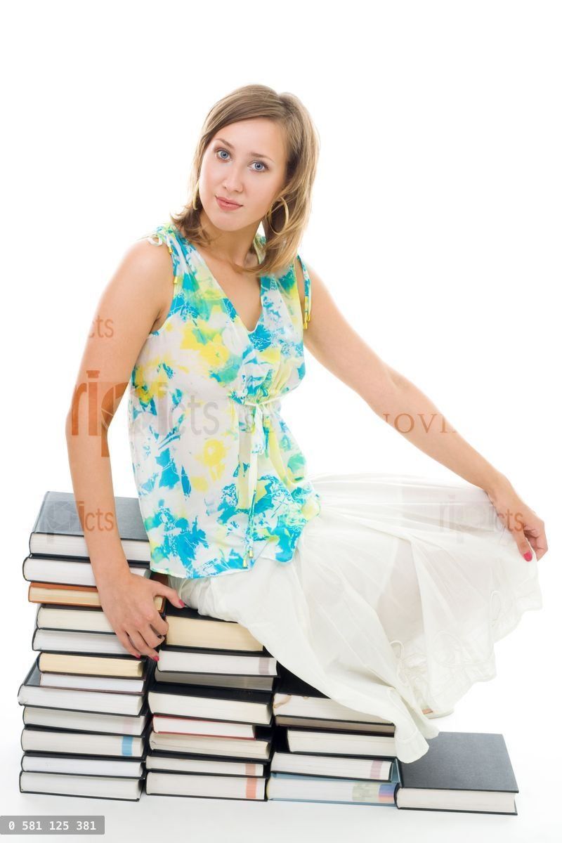 woman sitting on books