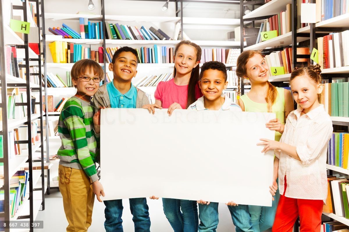 Friends holding white paper sheet in library