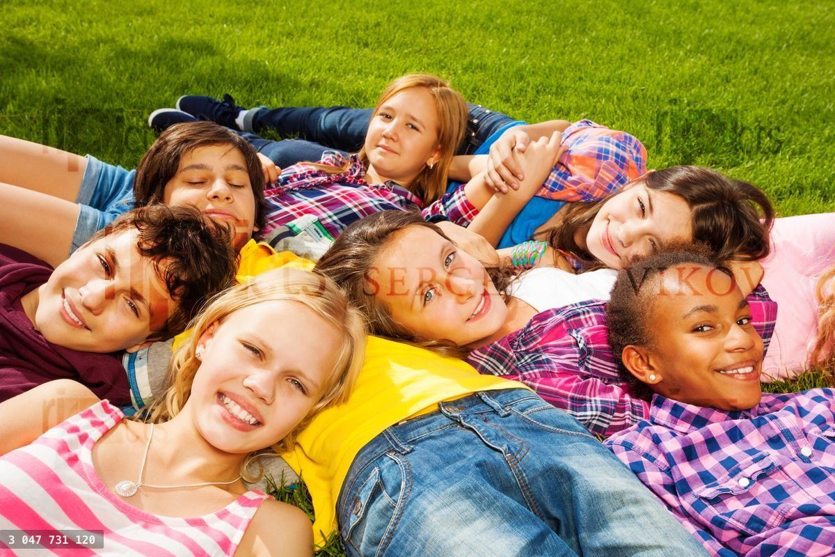 Group of children laying together and smile