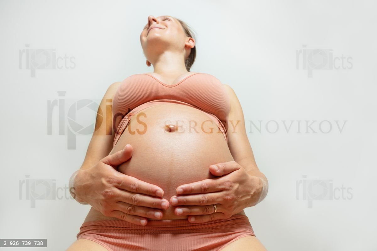 Funny view from below on pregnant woman's belly