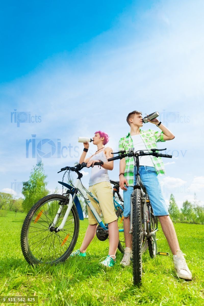Young bikers with water bottles