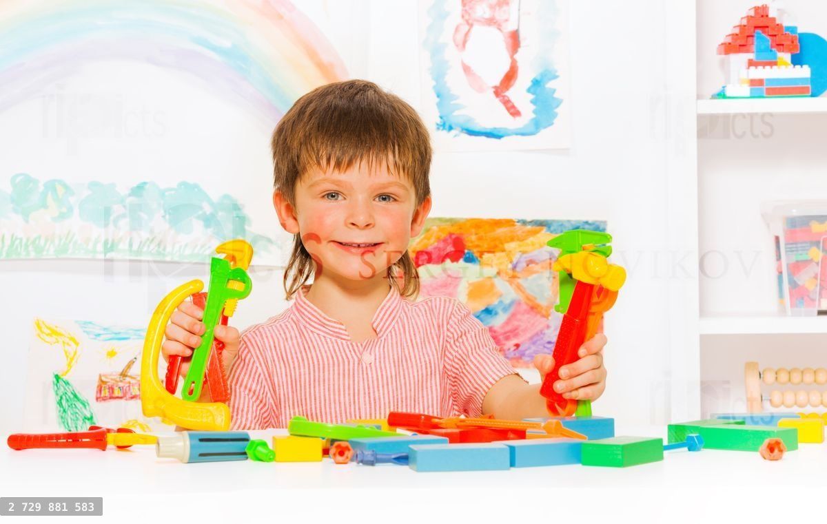 Happy boy learn to use tools like hamer and wrench