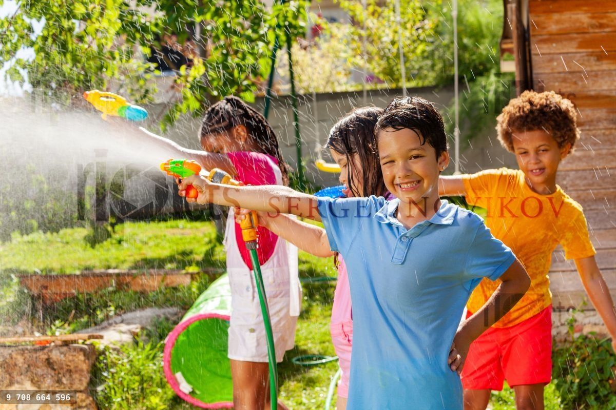 Boy and friends in water gun fight active fun game