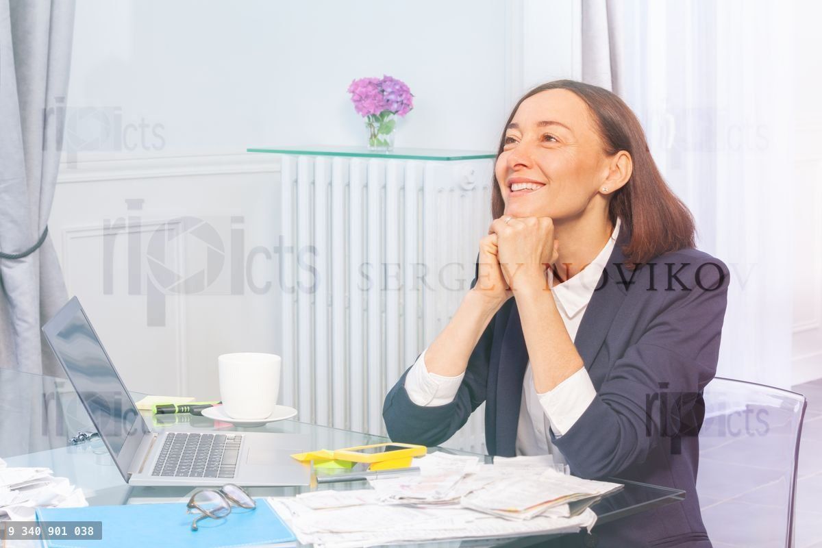 Happy businesswoman daydreaming in the office