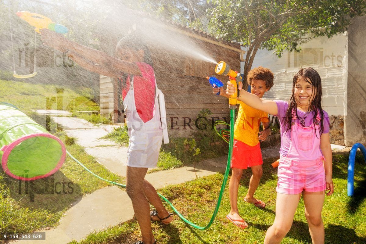 Girl and friends play water gun fight game outside