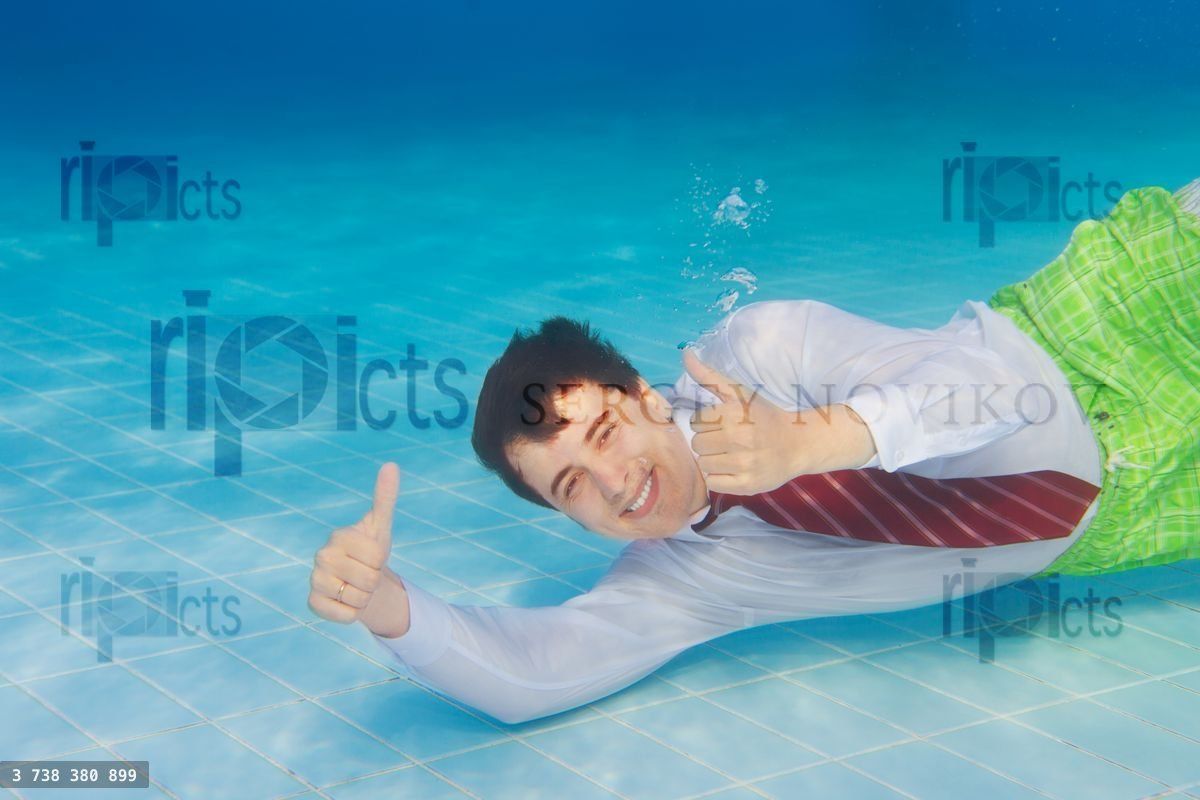 Happy businessman underwater