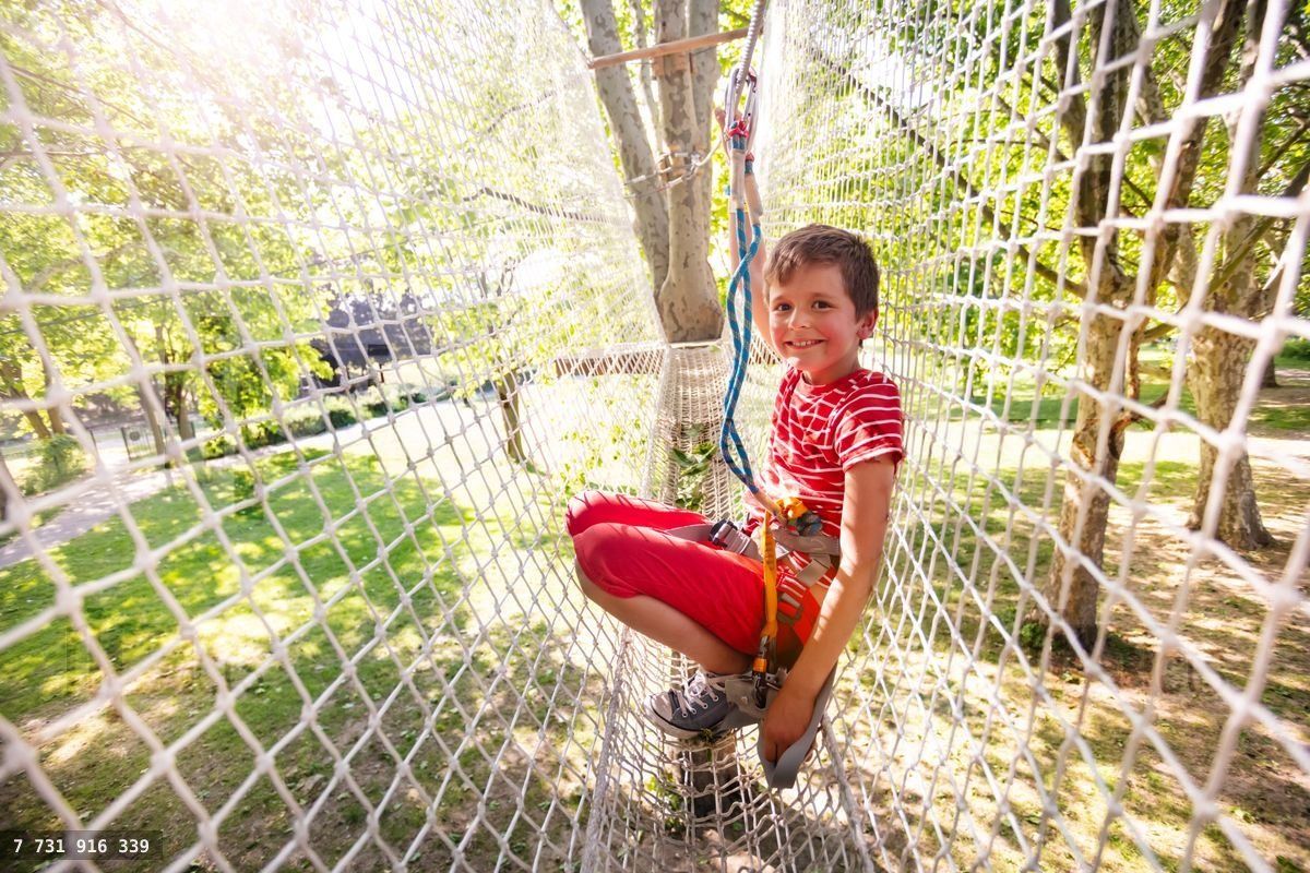 Fun at rope park little boy portrait in high net