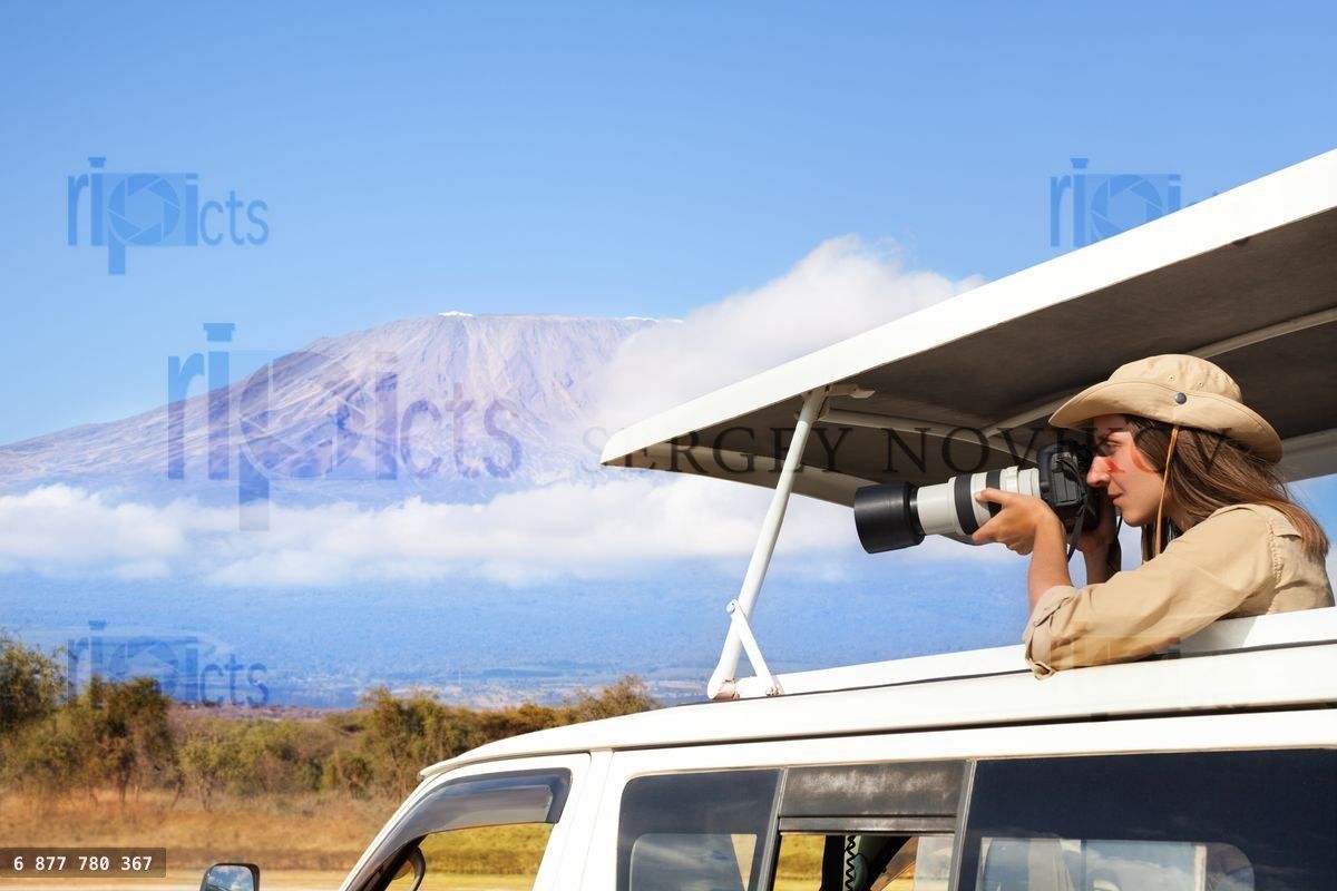 Woman taking shots during Kenyan safari game drive