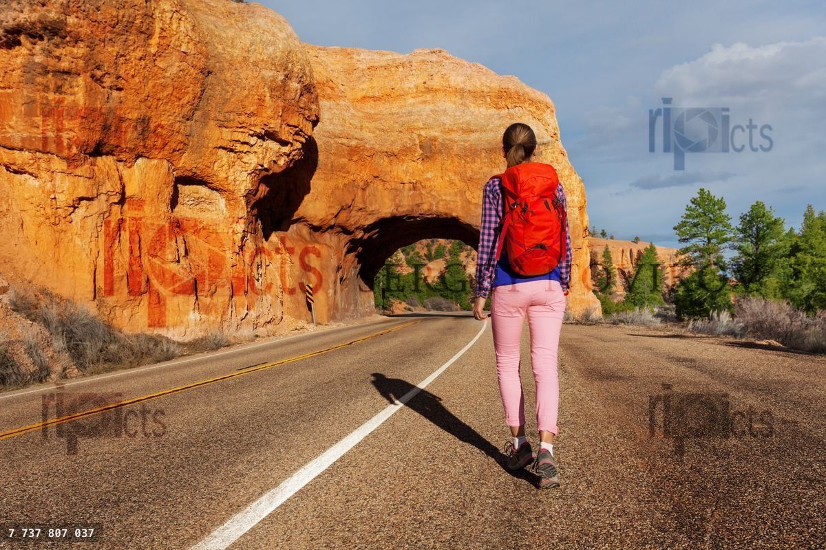 Woman walks on the road with Red canyon view