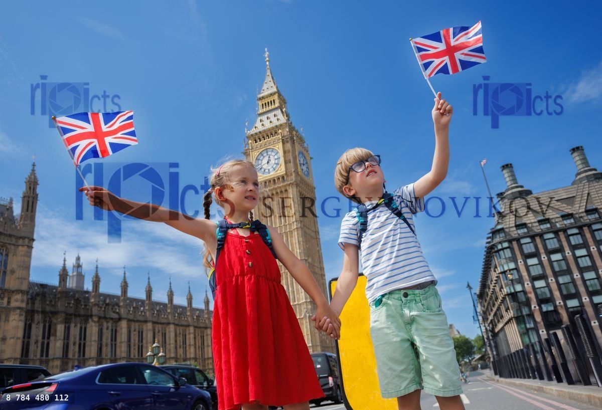 Young tourists with flags stand by London Big Ben in summer trip