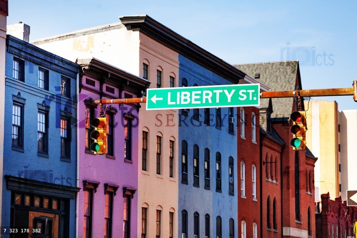 Guide sign at Baltimore street with colored houses