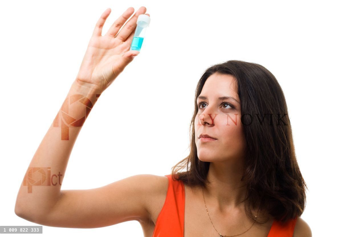 Woman look on blue test tube and thinking